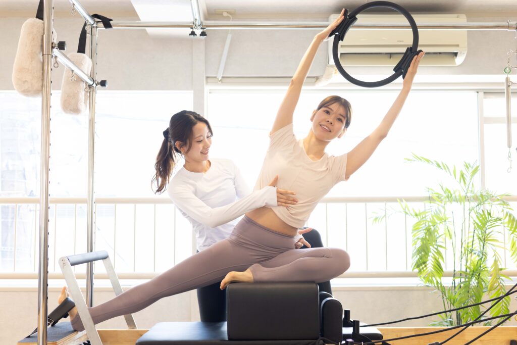 ピラティススタジオでピラティスをする女性